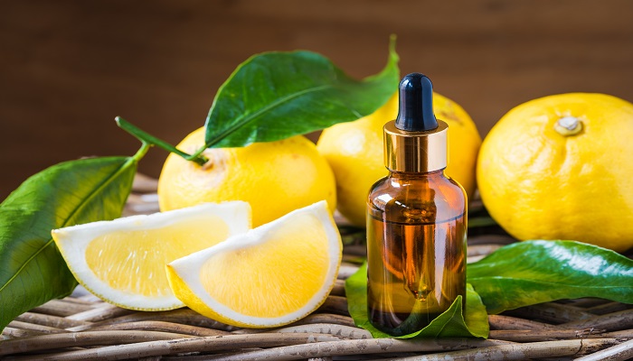 Citrus bergamot essential oil, aromatherapy or natural organic beauty cosmetic oil. Bottle of essential oil on rustic wood background.
